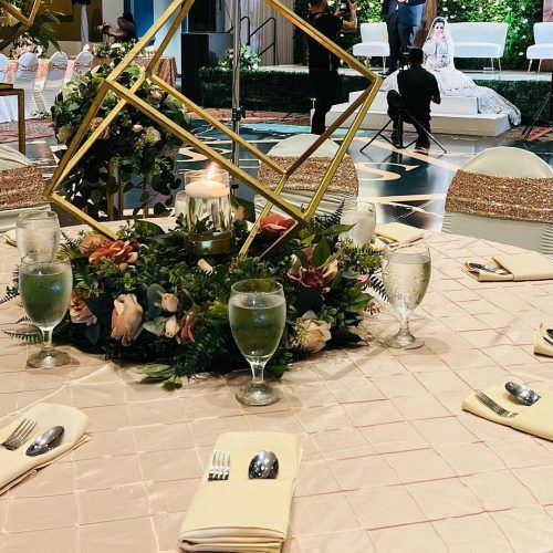 Gold geometric centerpiece with greenery